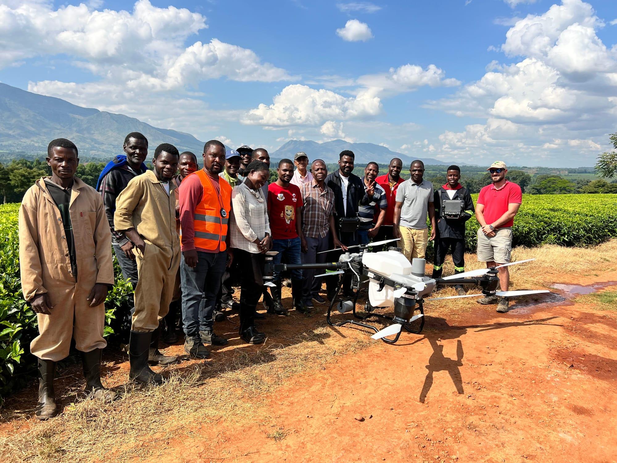 Serafin team and estate staff gathered around a spray drone